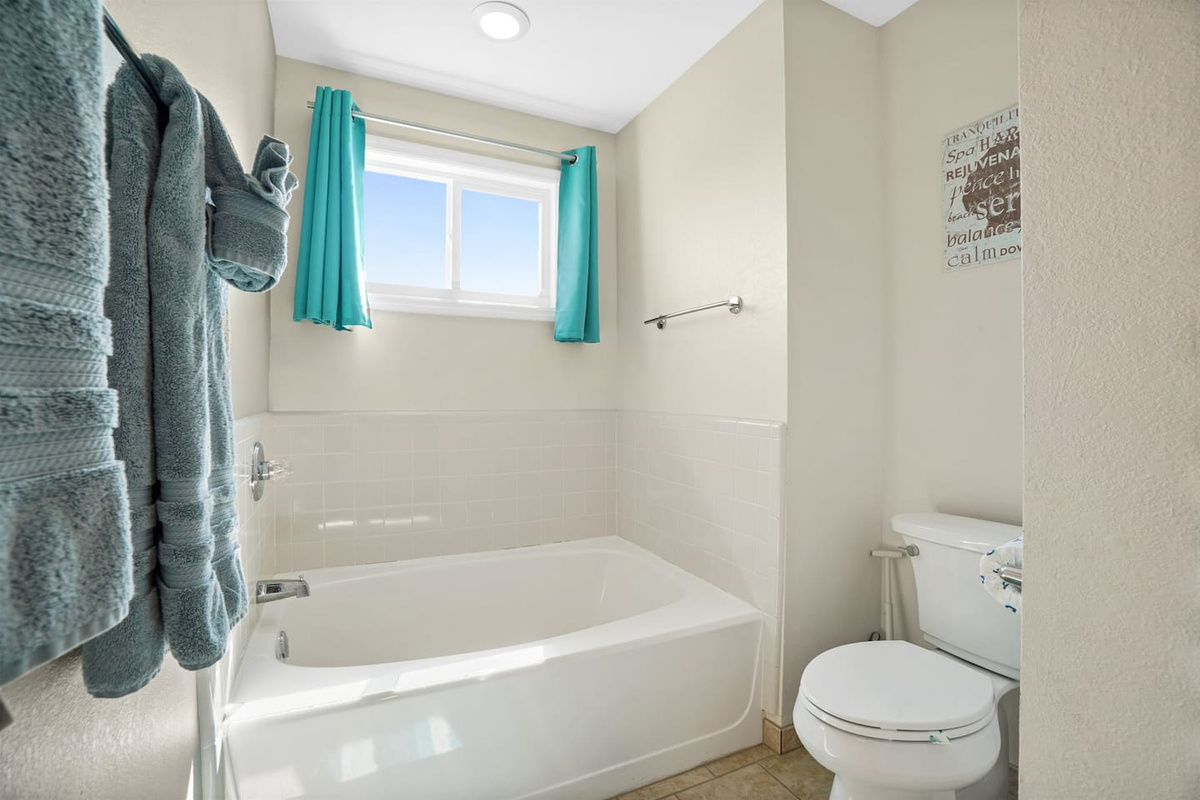Soak in the freestanding tub after a long beach day &mdash; you've earned every minute of this.