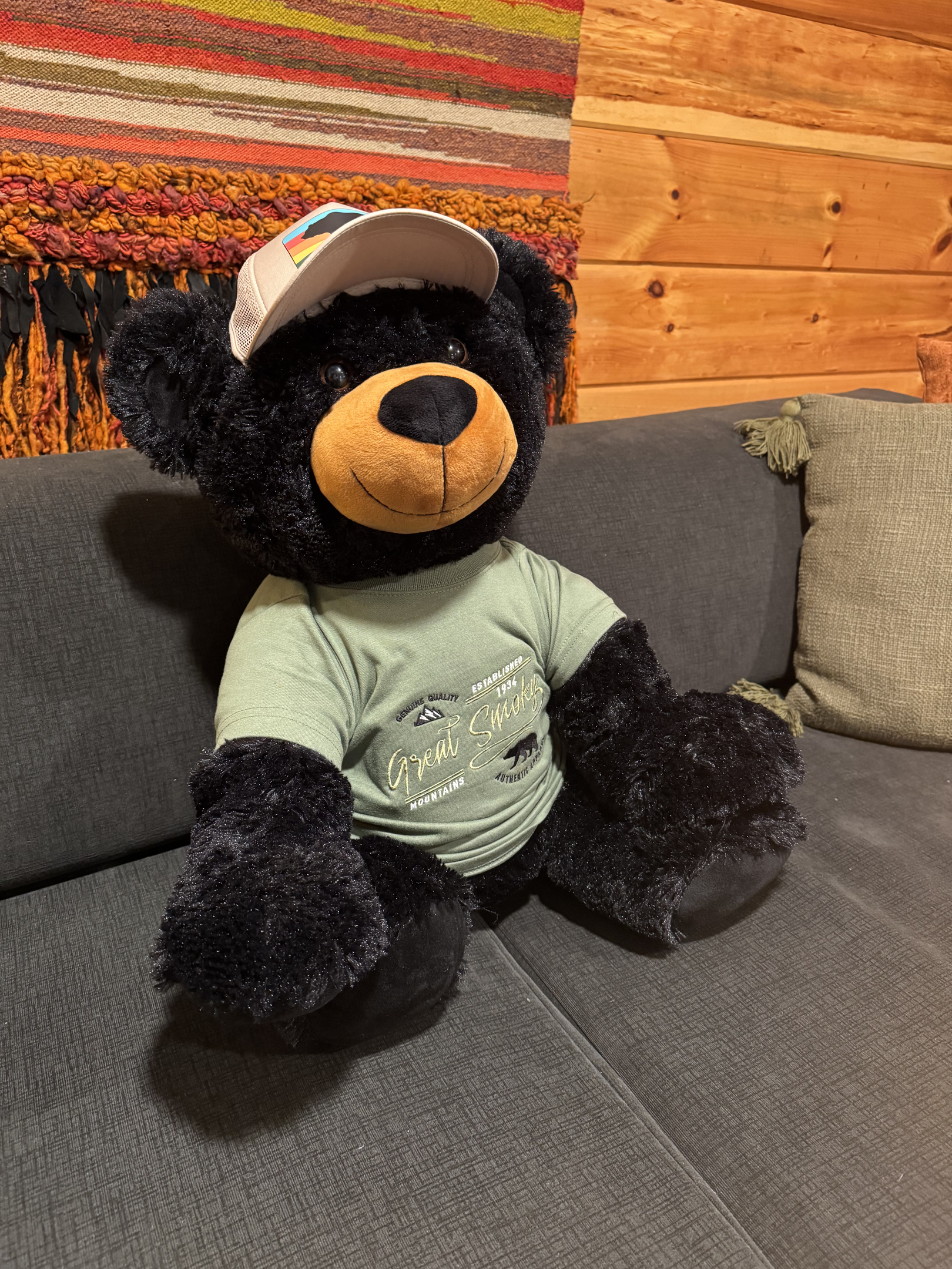 Your host Ridge Bear holding down the couch while the game room gets loud.