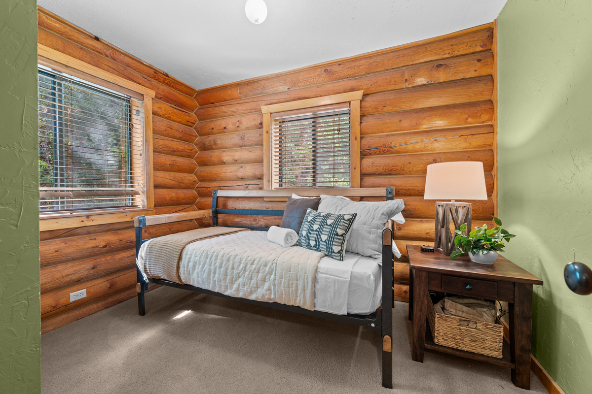 Cozy twin bedroom offering a quiet sleeping space on the main level.