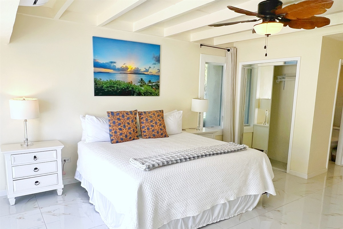 Peaceful bedroom retreat with cool tones and natural accents.