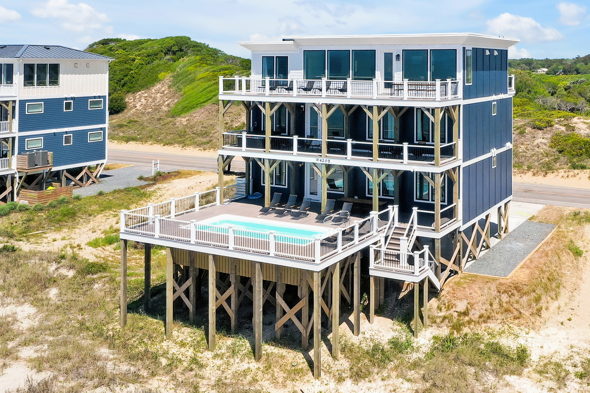 Pool on first deck, hot tub on second level, kitchen and outdoor dining on third