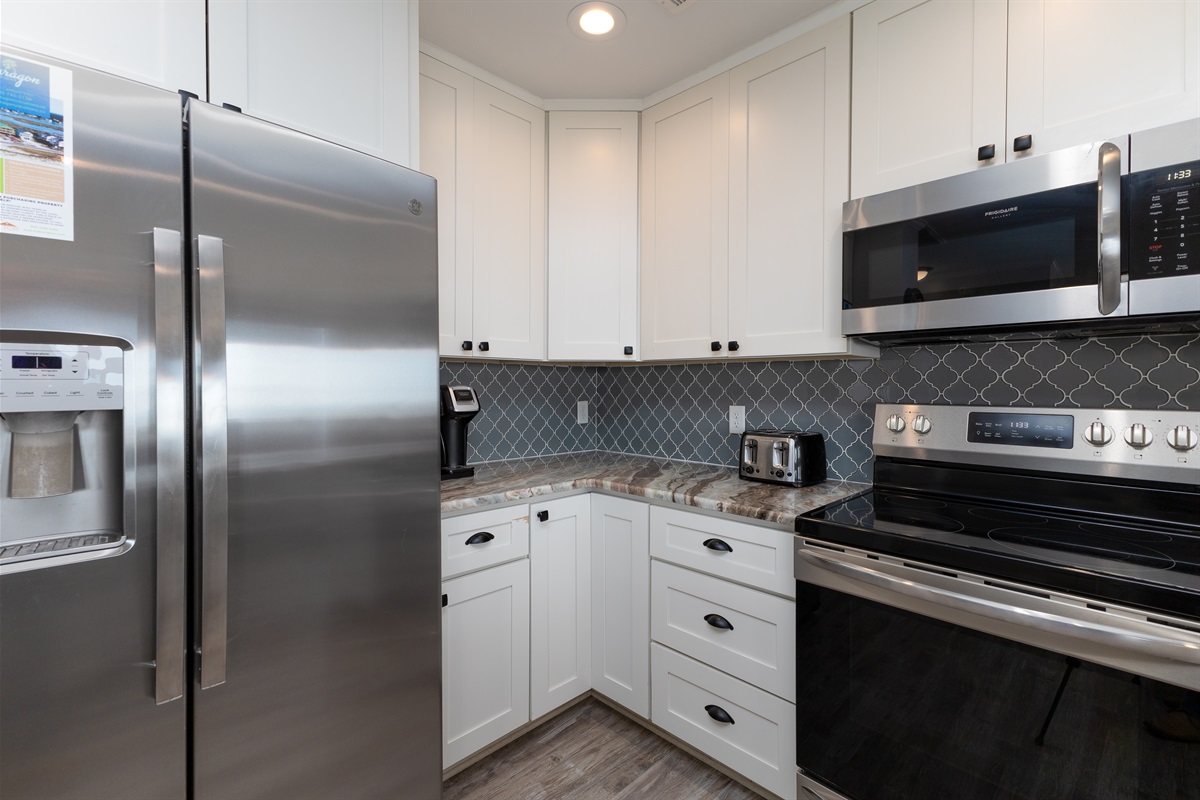 White cabinets and stainless steel appliances create a timeless kitchen