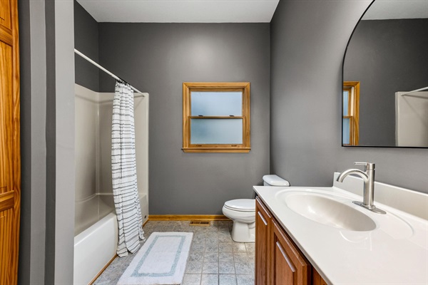 Bright, spacious bathroom with double vanity and tub/shower combo—plus a large closet for easy storage during your stay.