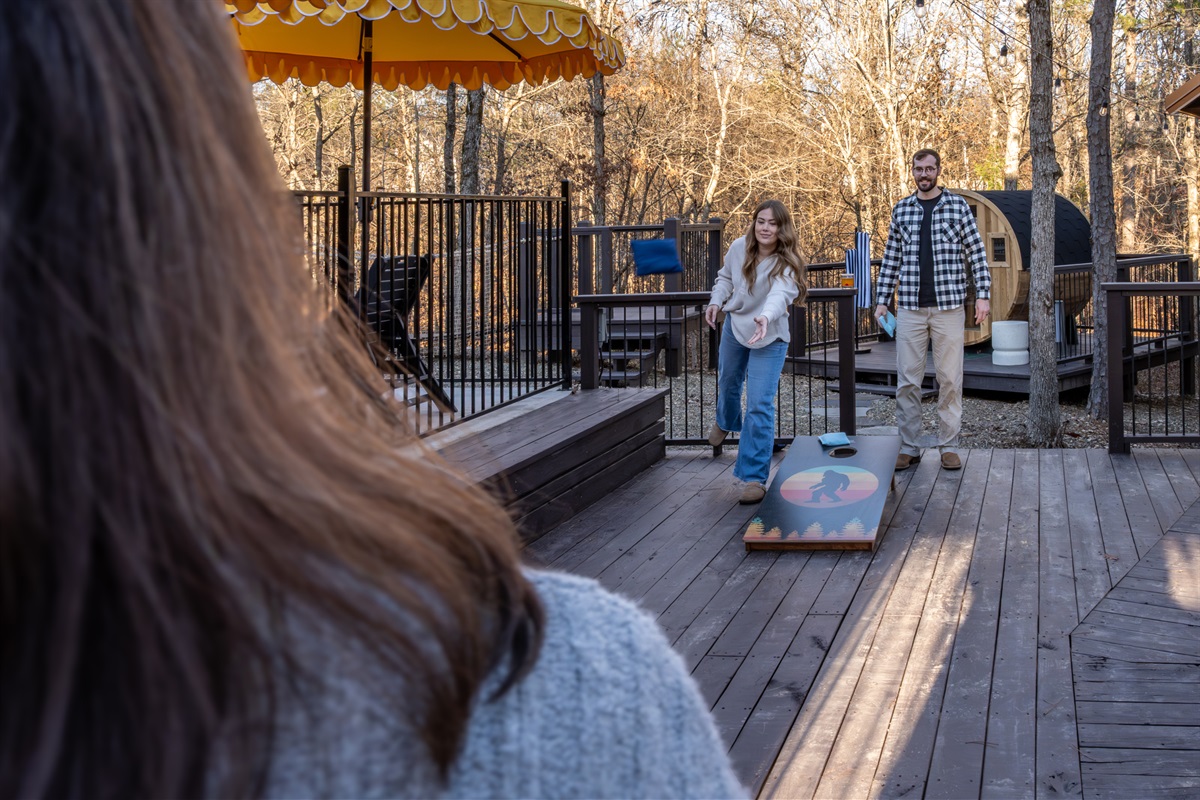 Outdoor Fun: Enjoy sunny days playing cornhole under the vibrant umbrella, surrounded by nature!