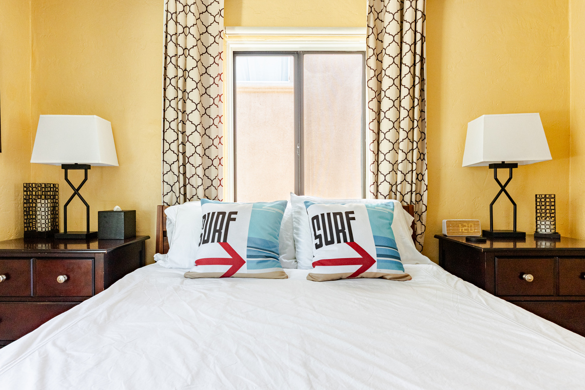 Main bedroom includes a comfortable queen size Casper memory foam mattress wrapped in high end linens and adorned with plush pillows. There's also a ceiling fan for warm summer nights.
