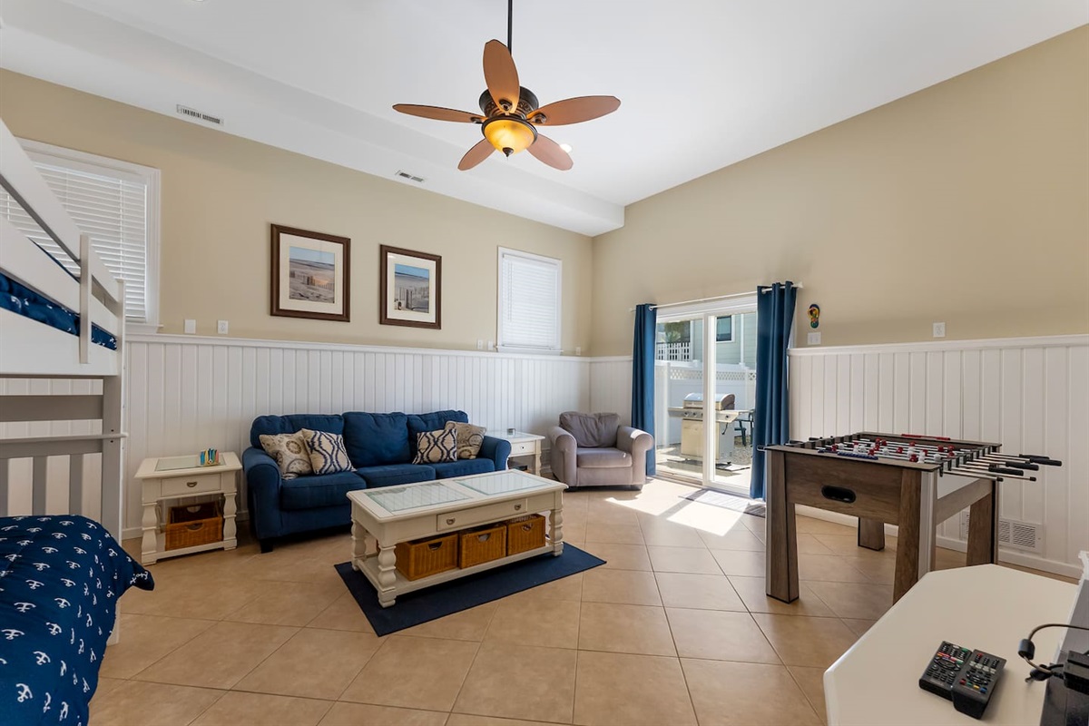 Bonus room with HDTV, Foosball Table, Bunk beds and ample seating for games and entertaining. With direct access to private fenced in yard featuring BBQ Grill. 