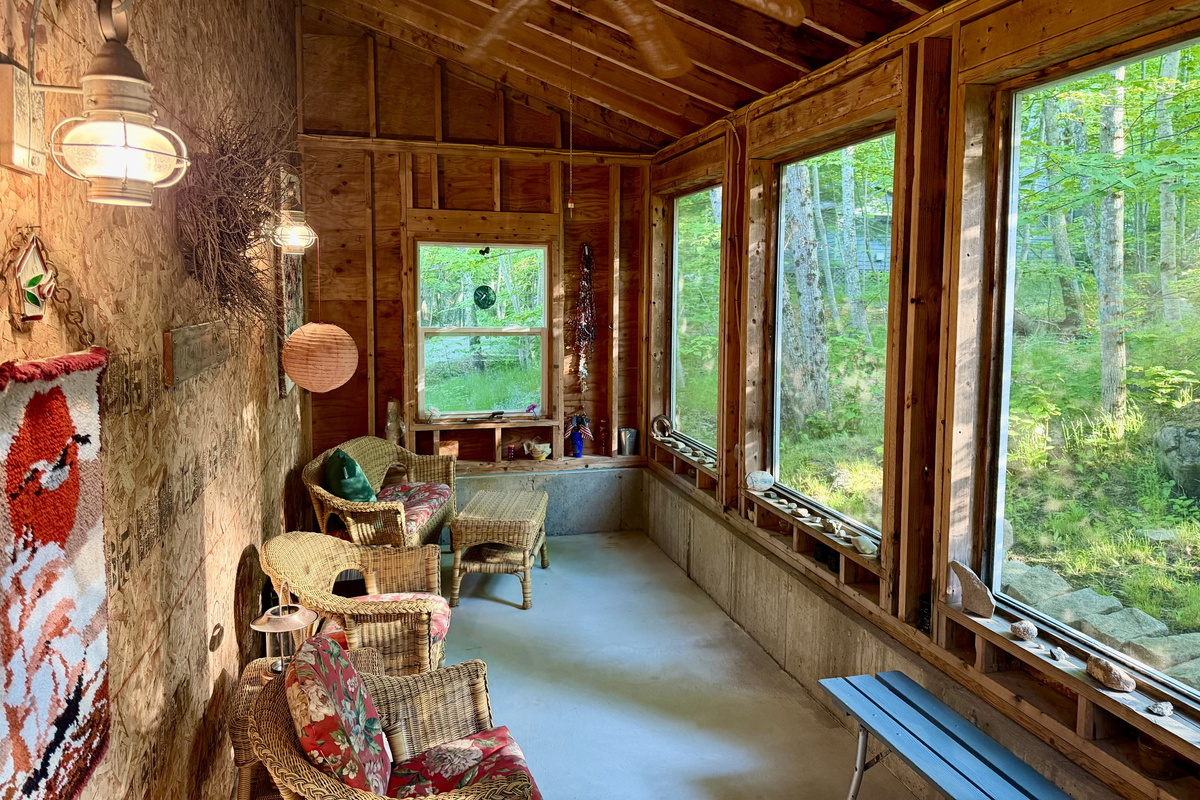 Look at all this extra room to stretch out. The Settler’s Sidecar interior boasts comfortable wicker seating, an overhead fan, and floor-to-ceiling screens framing lush woodland views. A peaceful, bug-free sanctuary on the property.