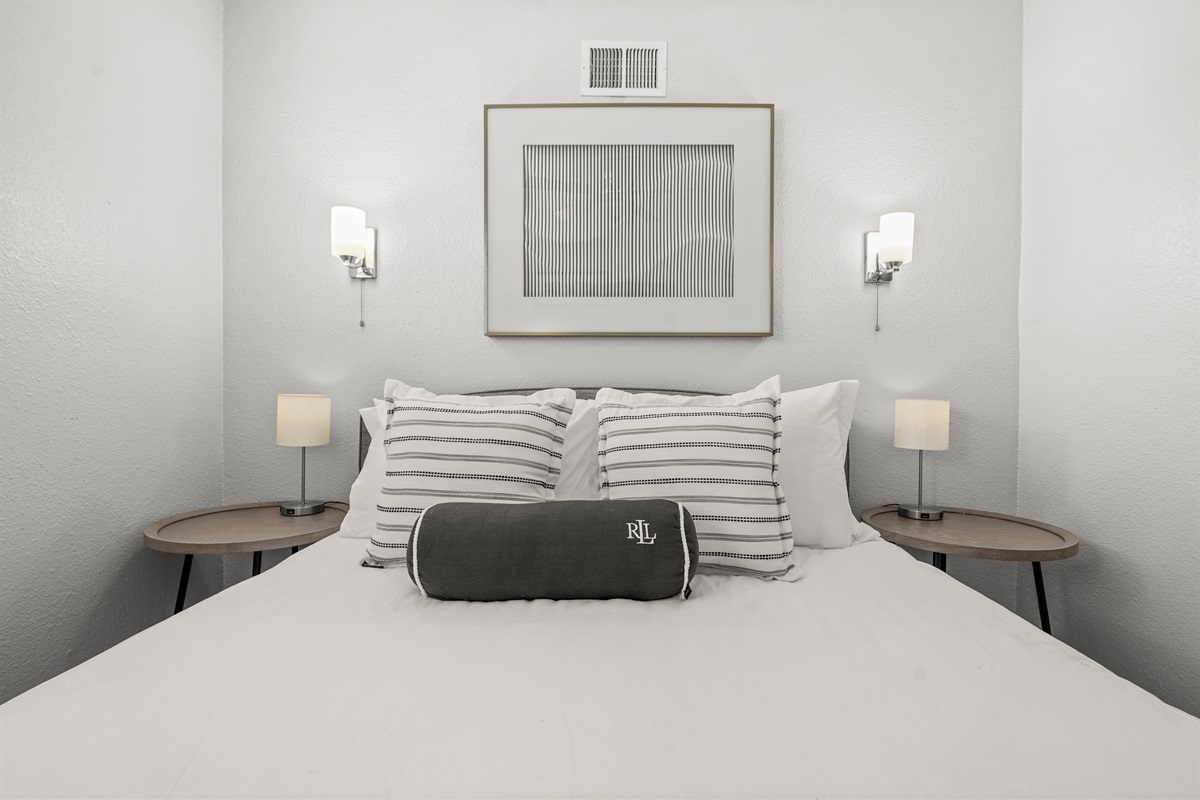 Comfortable upstairs bedroom with a queen bed and closet space for guest belongings.