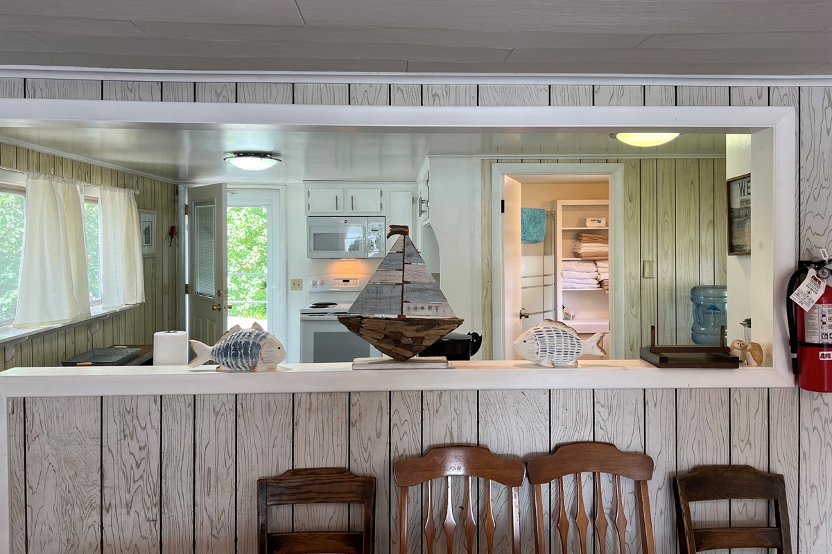 Dining area with kitchen and bathroom beyond
