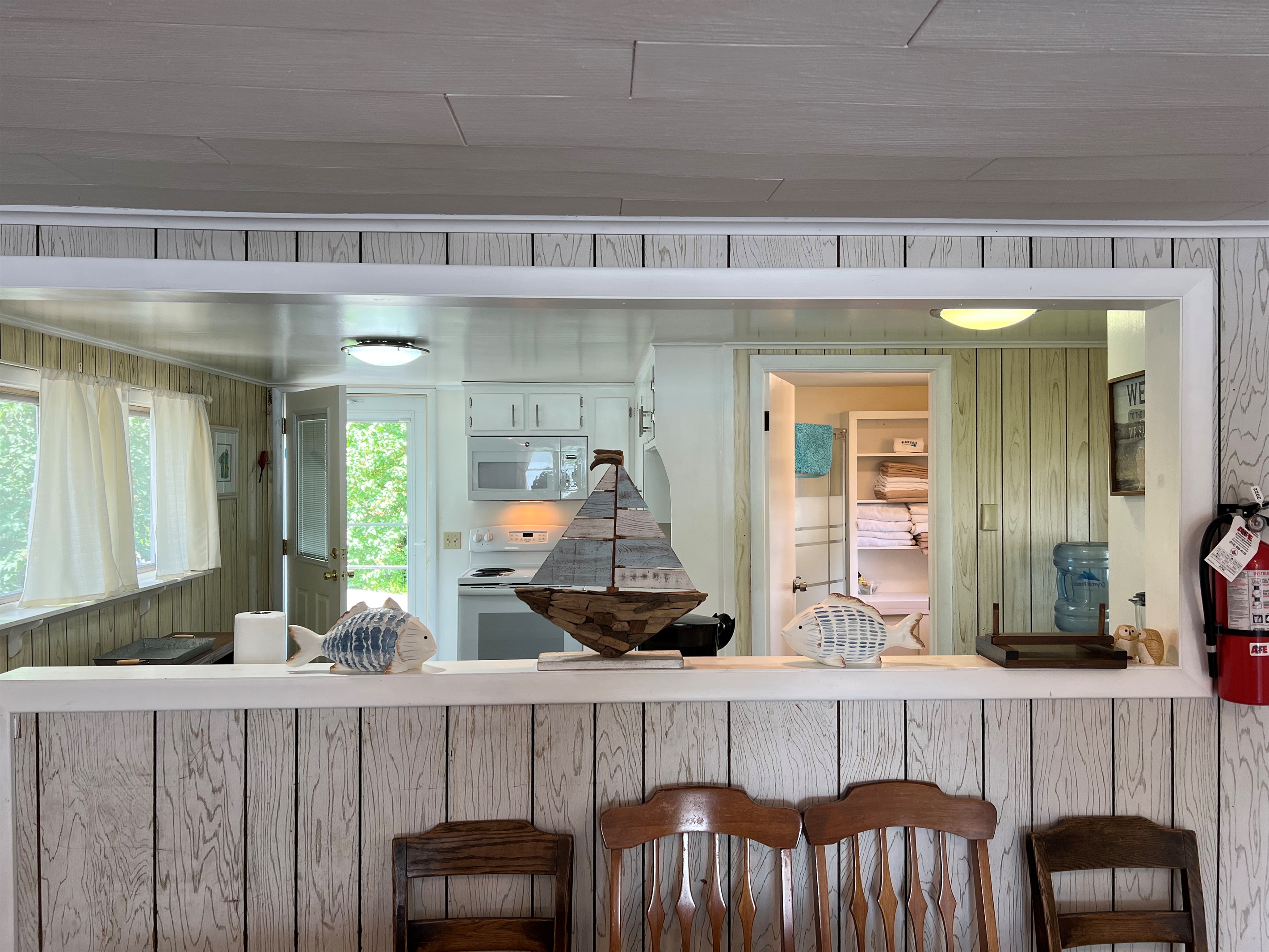 Dining area with kitchen and bathroom beyond