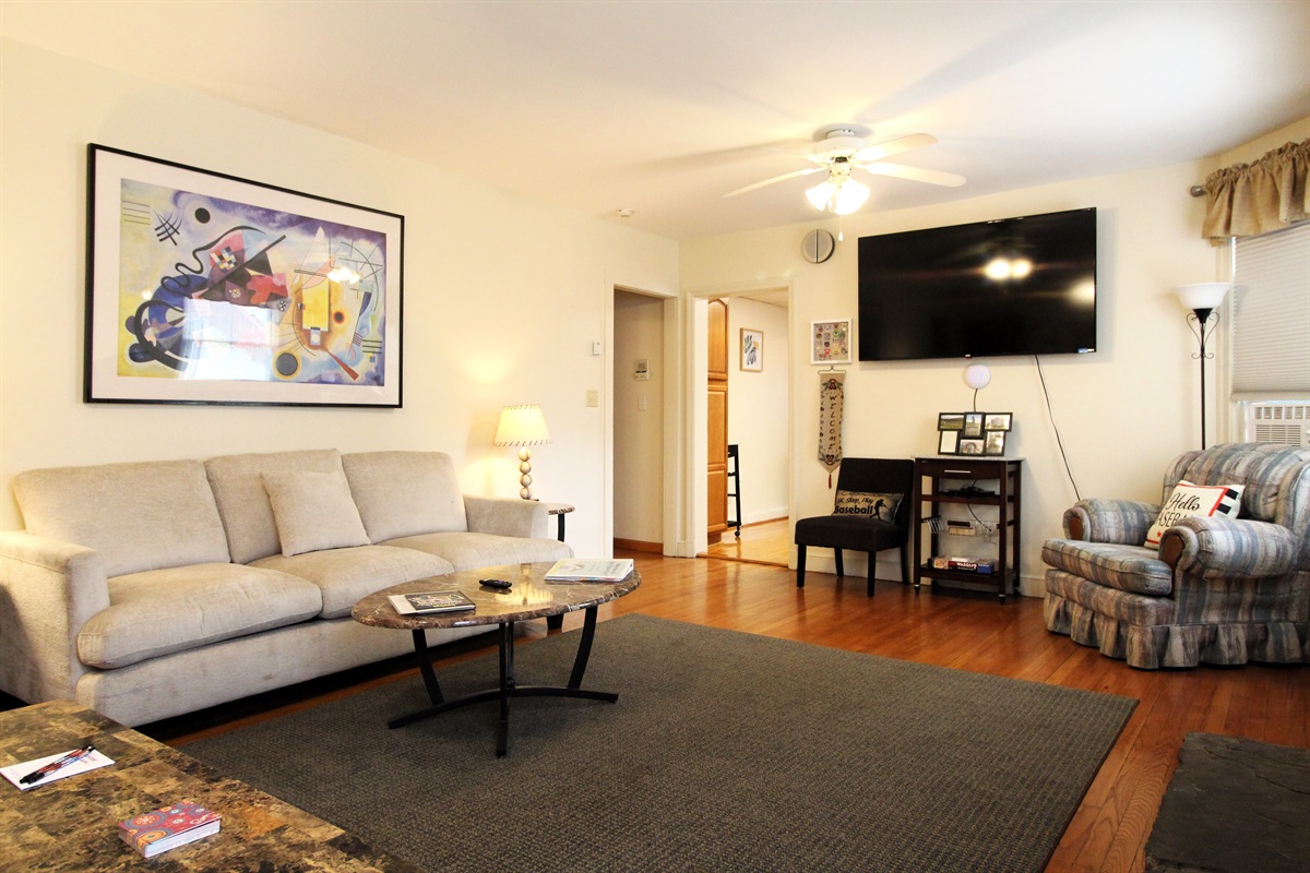 Living Room.  There are hardwood floors throughout the unit, with a granite tile floor in the fully tiled bathroom