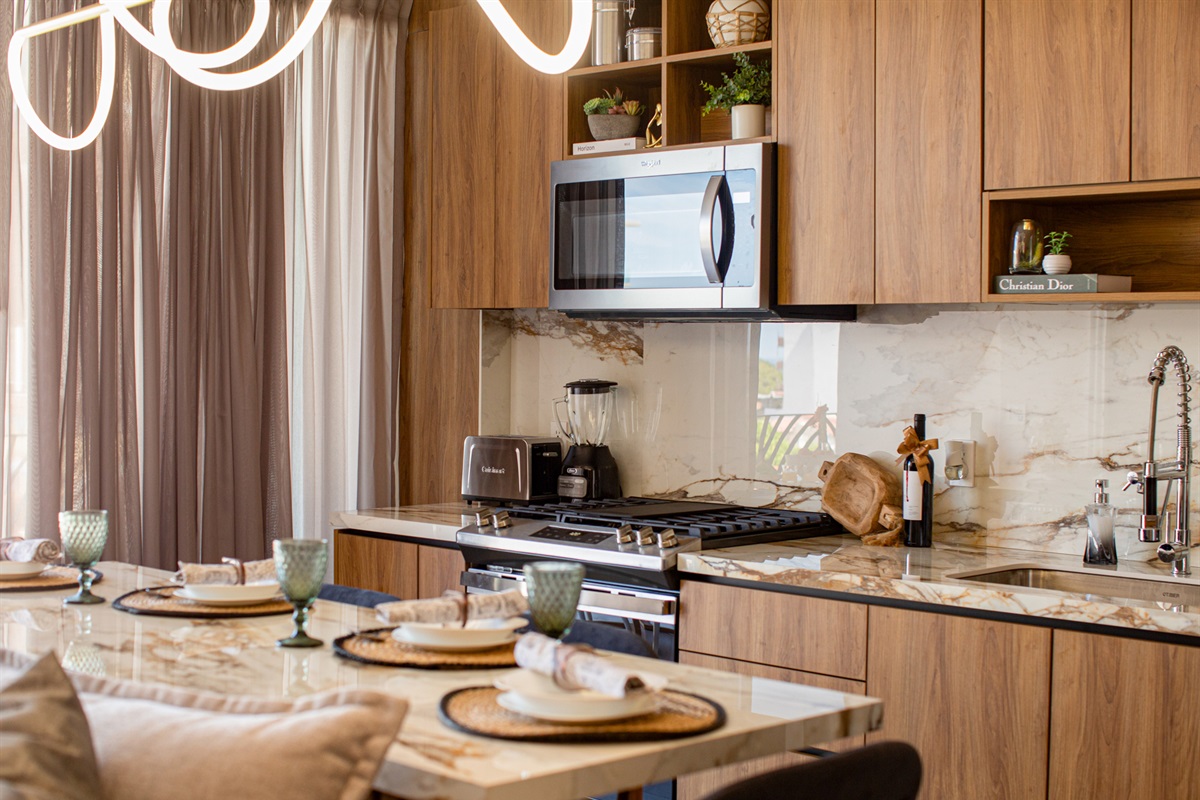 A bright, open-concept layout connects the chic living room to the modern kitchen—perfect for cooking, relaxing, and entertaining