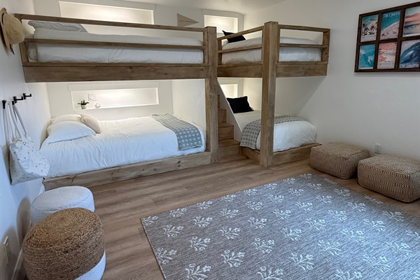 Thoughtfully designed custom build bunk room. Two Queen and Two Twin XL beds