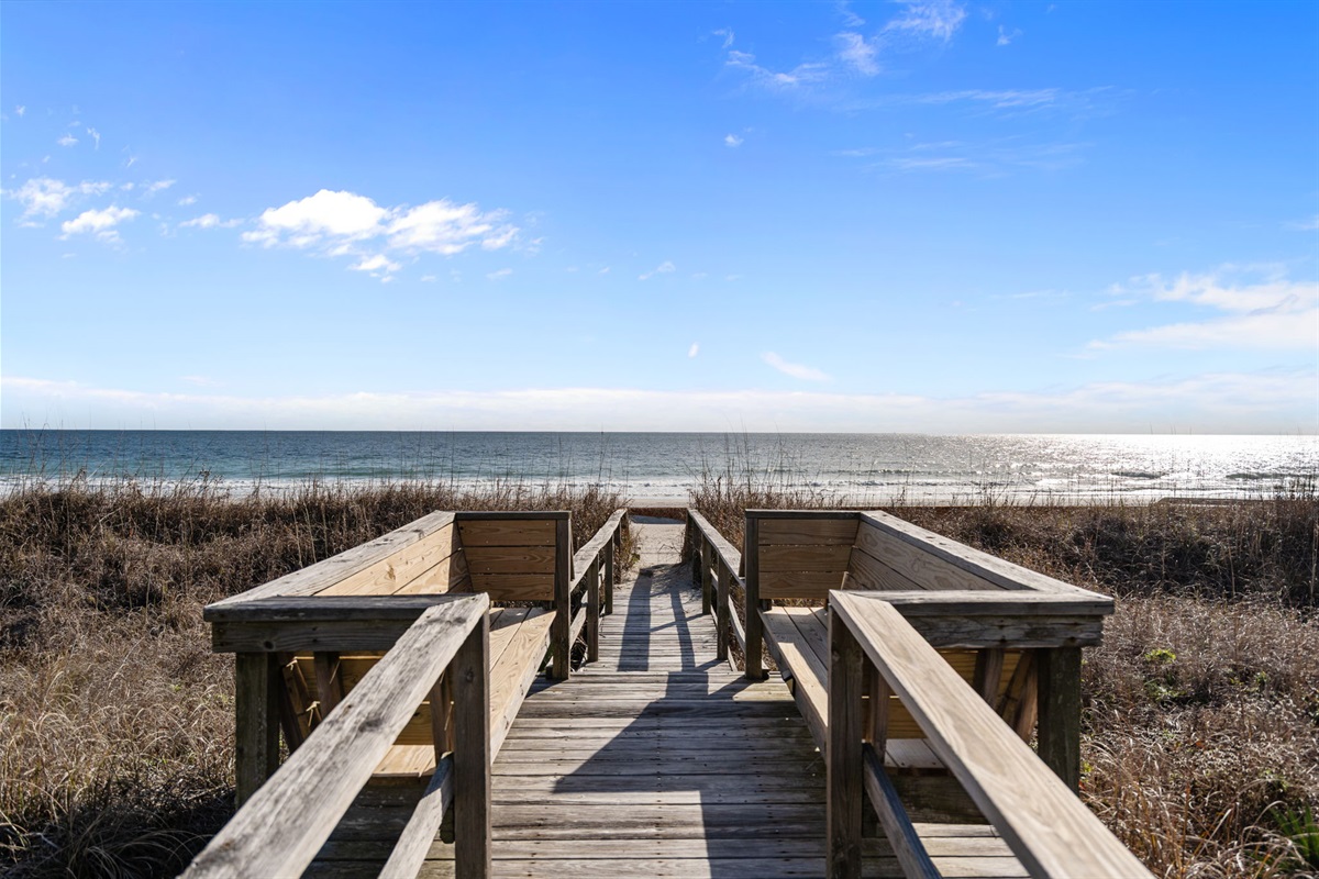 Private walkway direct beach access with seating to watch fireworks, sunsets, sunrises, or dolphins - steps from the private saltwater pool and outdoor showers