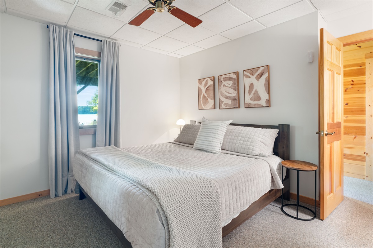 Wake up to lake views in this serene king bedroom with memory foam mattress and plush bedding. Enjoy the ceiling fan, dresser, full closet, and luggage racks. A full bath is just steps away.