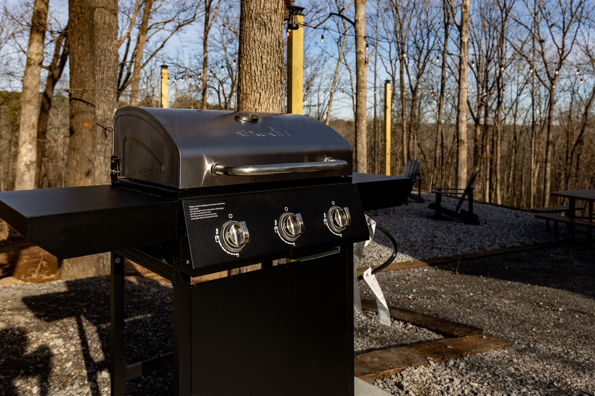 Enjoy cooking outdoors on your private grill, just steps from the fire pit and seating area—perfect for relaxed evenings surrounded by the quiet forest.