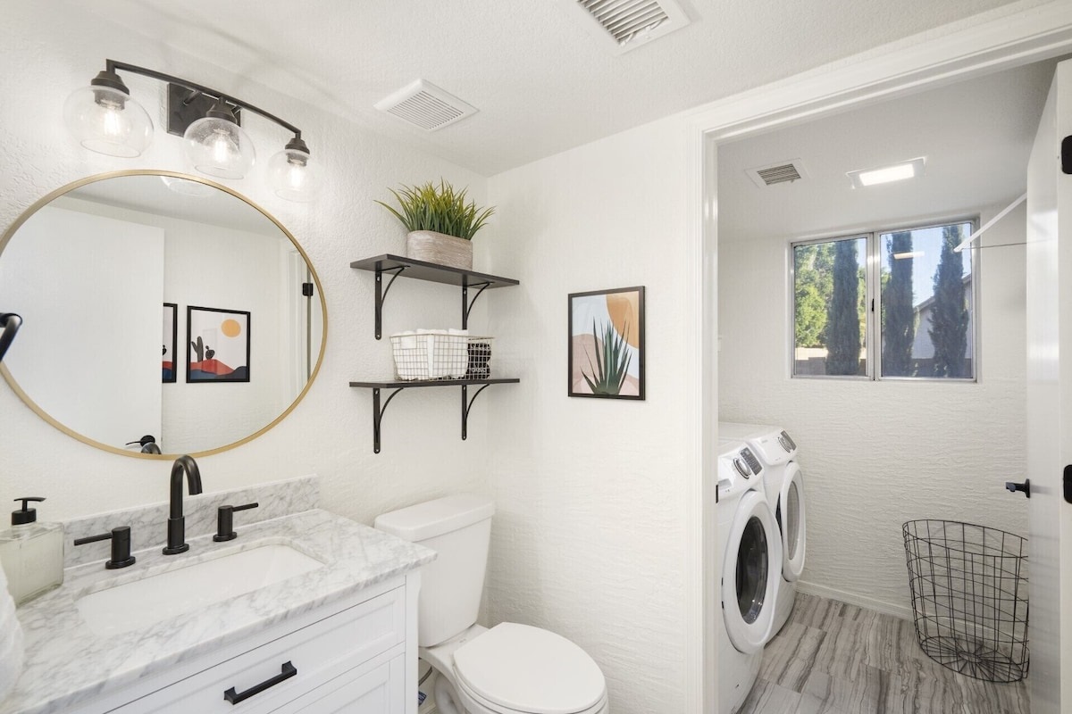 Downstairs powder room with adjacent laundry room