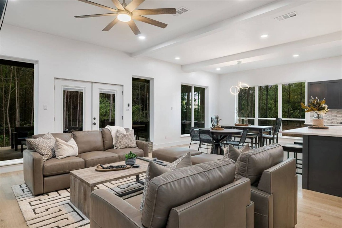 Bright living space with large windows and forest views.