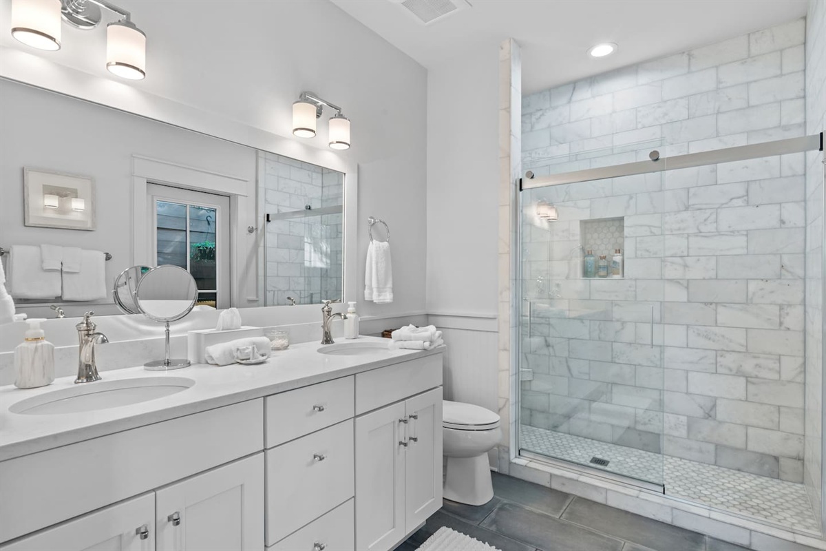 Upstairs king suite bathroom with double vanity, marble shower, and outdoor shower
