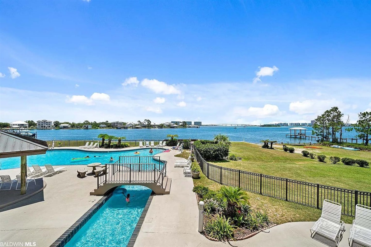 Outdoor Oasis: Relax by the pool with stunning views of the water and lush greenery!