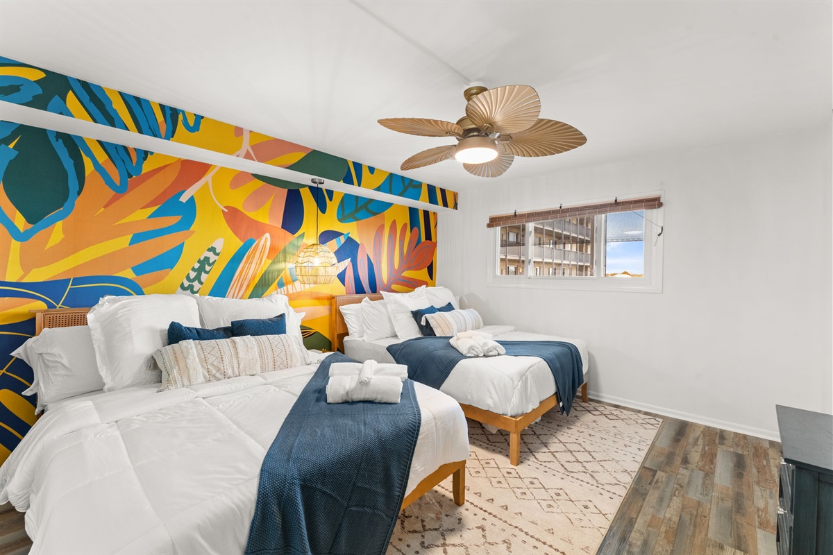 The second bedroom has two queen beds, a ceiling fan, closet, 55 inch smart tv and closet. Plenty of bed side charging points