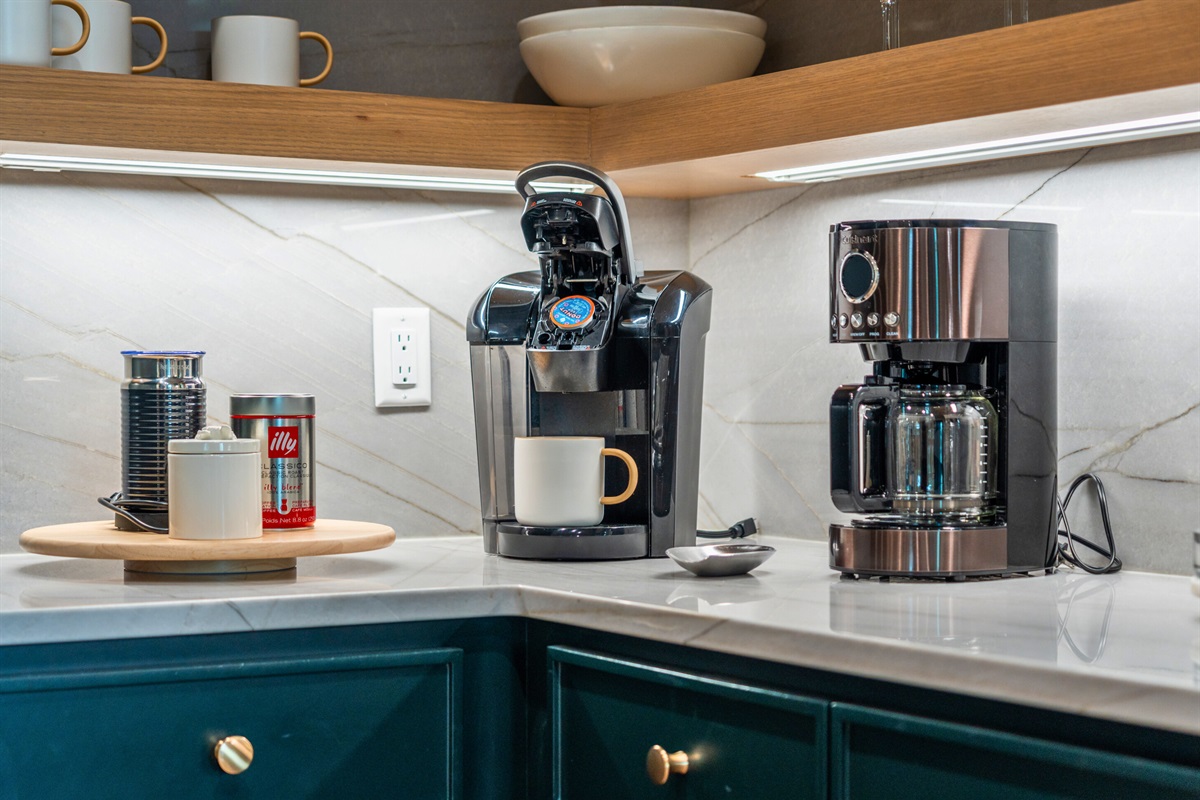 Start your day right with a fresh cup of coffee from this well-equipped kitchen corner. The stylish appliances and thoughtful design make it a perfect spot for your morning routine.