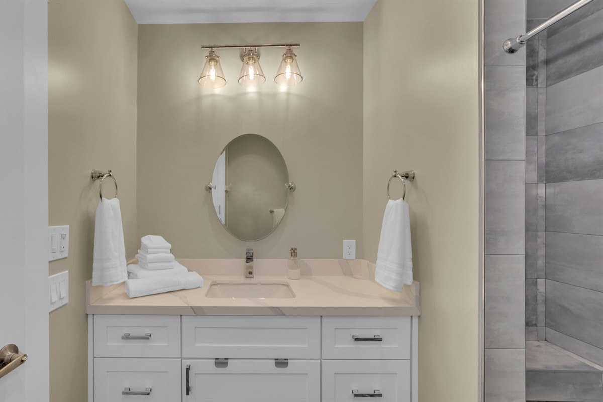 Bright, spa-inspired bathroom with plush towels, modern finishes, and a walk-in shower, designed for comfort after a day visiting the zoo and Balboa Park.