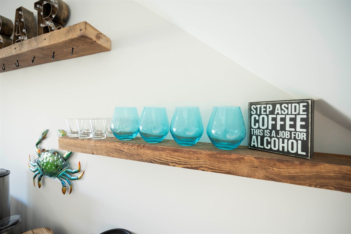  Charming home bar setup with crab decor, funny sign, and stylish glassware!
