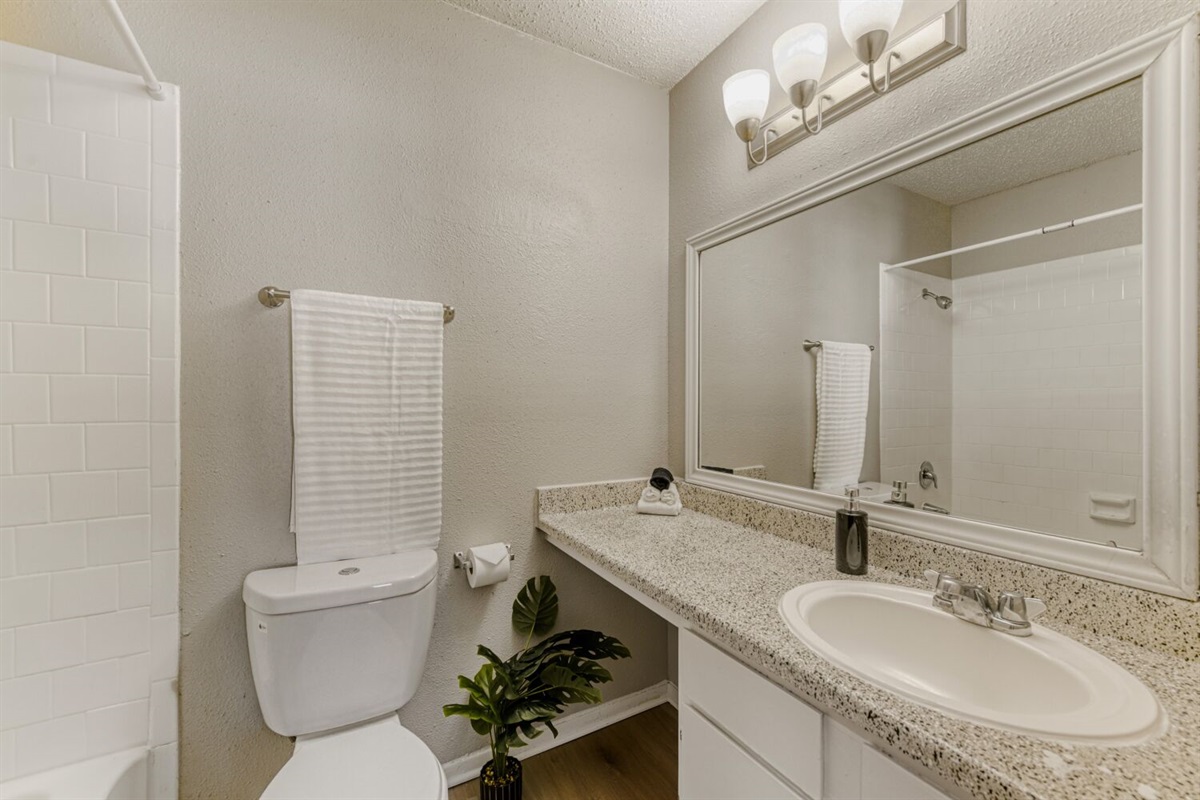 Bright and clean bathroom with modern lighting and neutral tones.
