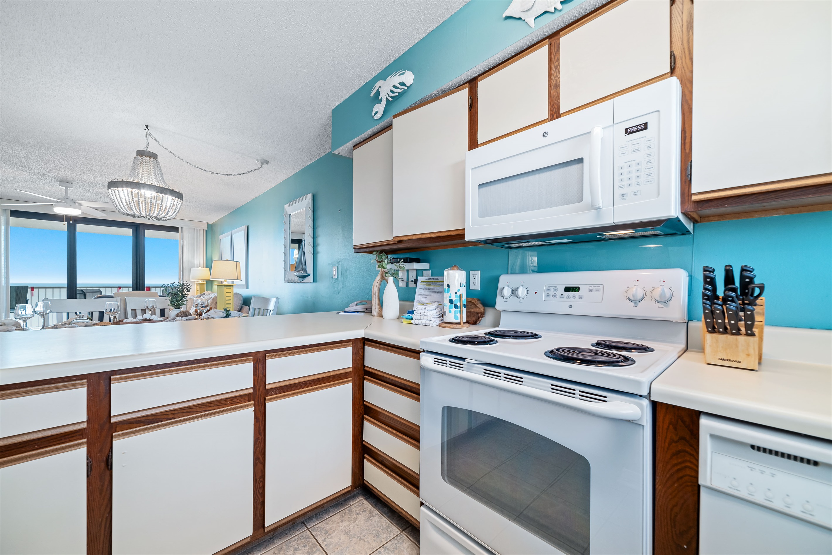 This fully functional kitchen boasts stainless steel appliances, sleek countertops, a decorative backsplash, and ample cabinet storage, ideal for everyday cooking and entertaining.