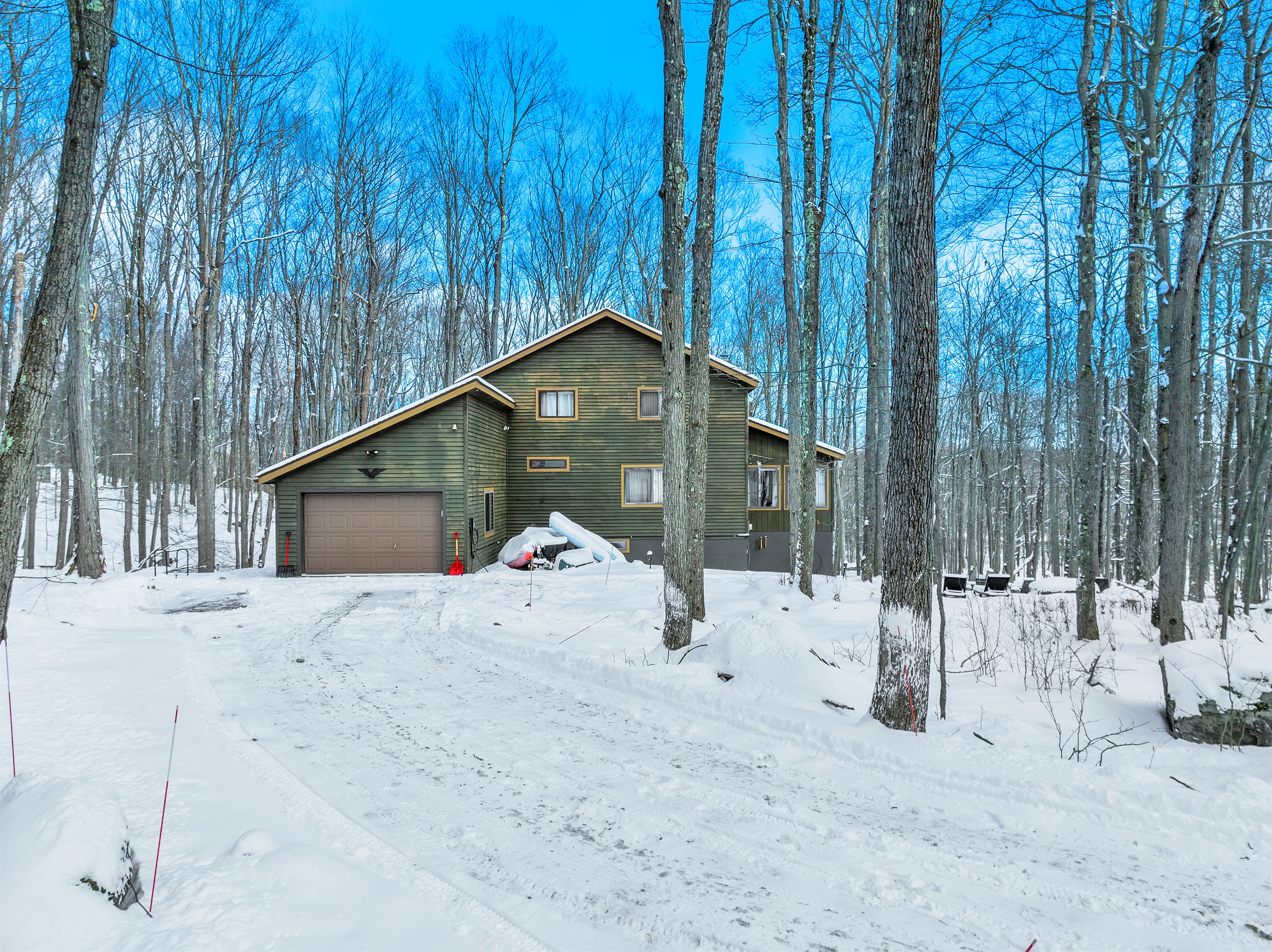 “Snowy bliss — your secluded winter escape awaits among the trees.”