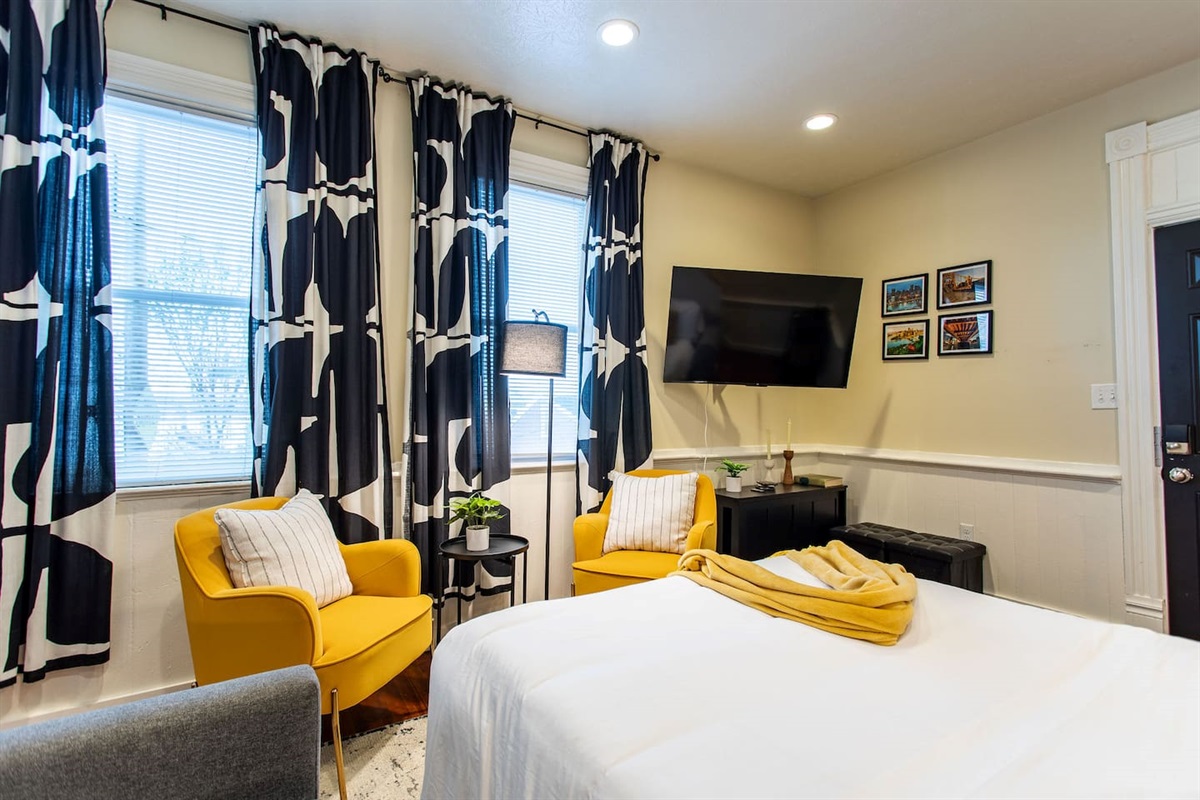 A warm and inviting living area featuring a plush sofa, soft lighting, and a dedicated workspace with a sleek desk and comfortable chair, perfect for productivity and relaxation.