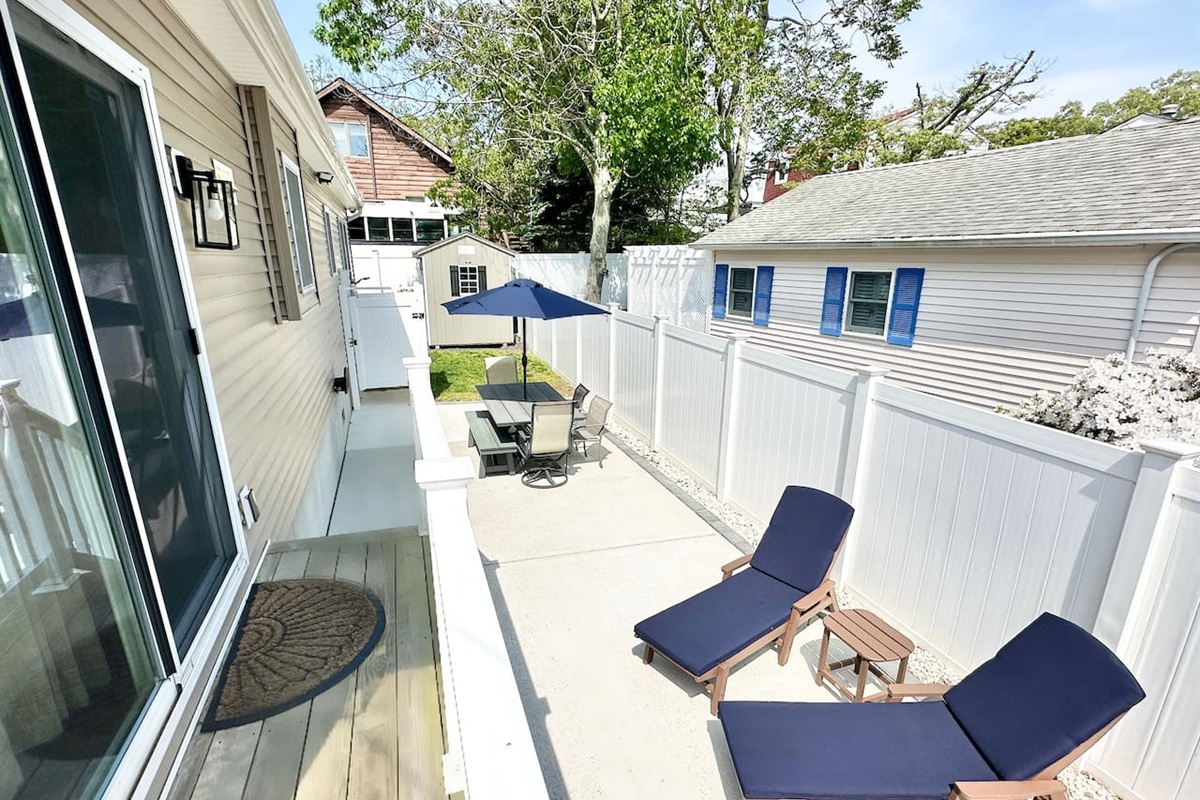 Step right out of the sliding glass doors onto a clean, private patio. This sunny nook is perfect for basking on the lounge chairs or enjoying a snack at the outdoor table. It’s a peaceful, fenced-in spot for some quiet relaxation.