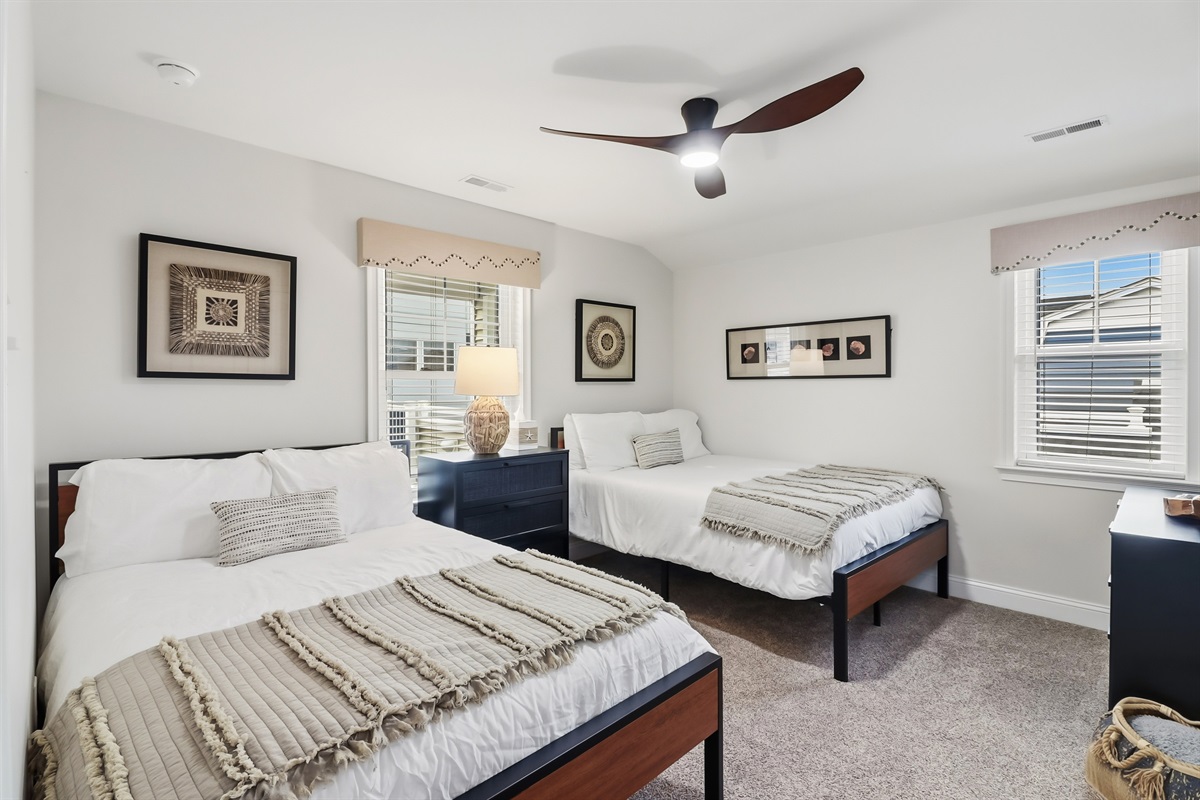 Peaceful twin bedroom with coastal accents and soft carpeting
