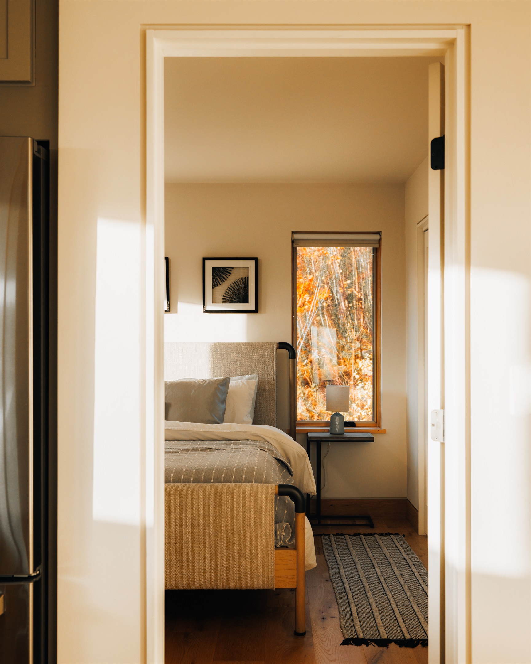 Upstairs king bedroom tucked behind the doorframe with built-in desk and TV.