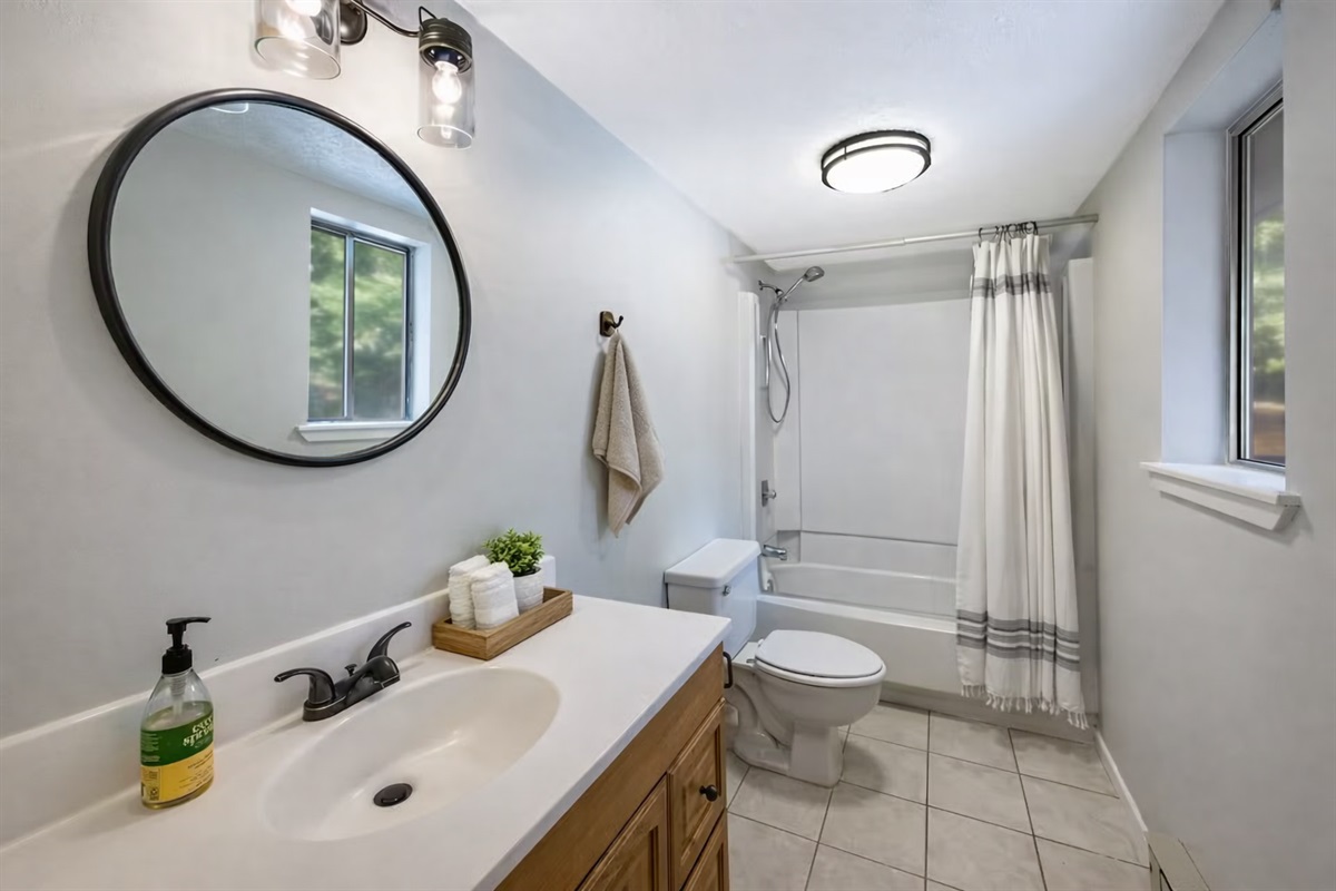 Clean, modern full bath with fresh linens and bright natural light.