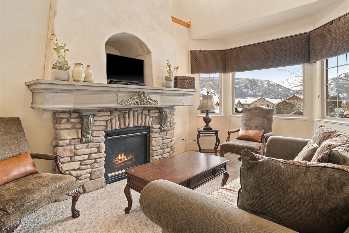 Inviting living room with stone fireplace centerpiece