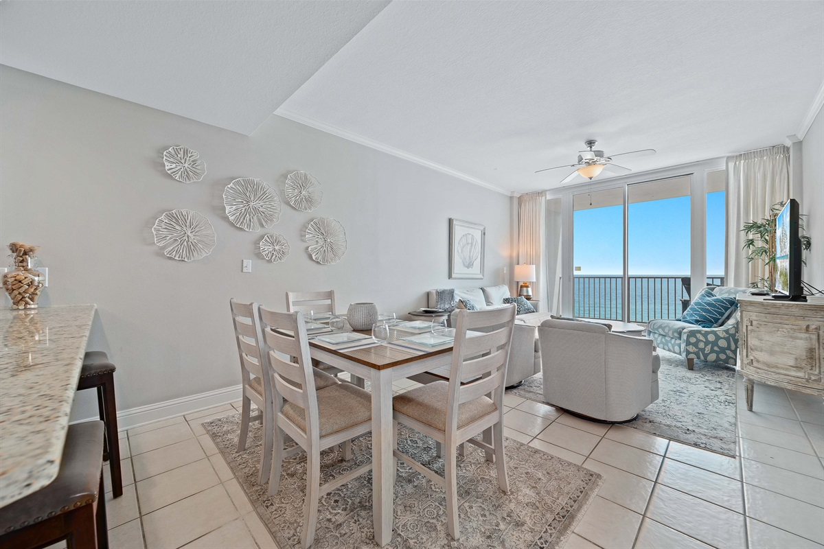 A comfortable living room with ample seating, flowing into a dining area, ideal for everyday living and gatherings.