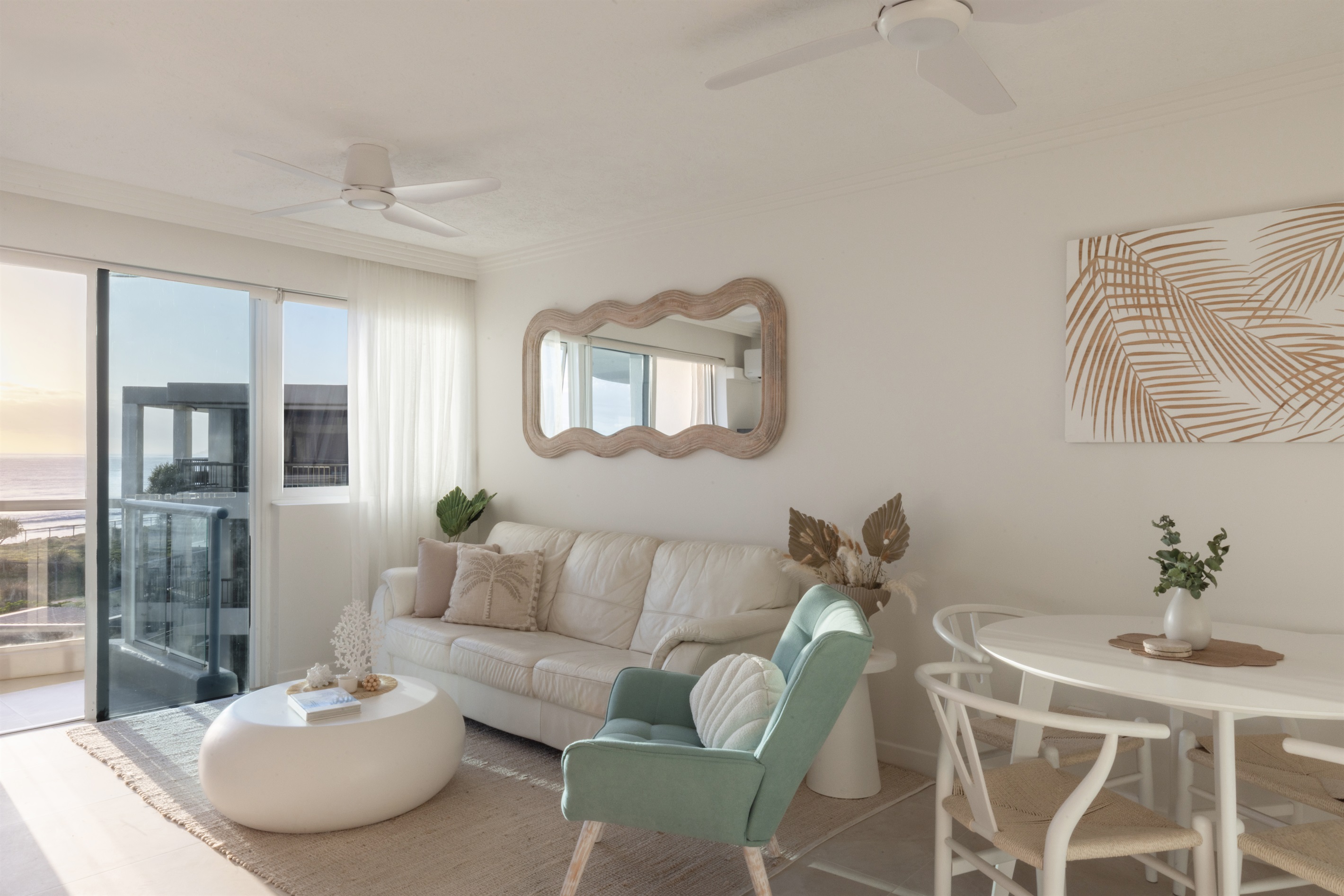 Modern coastal living room with Smart TV, air-conditioning & easy balcony access to ocean views.