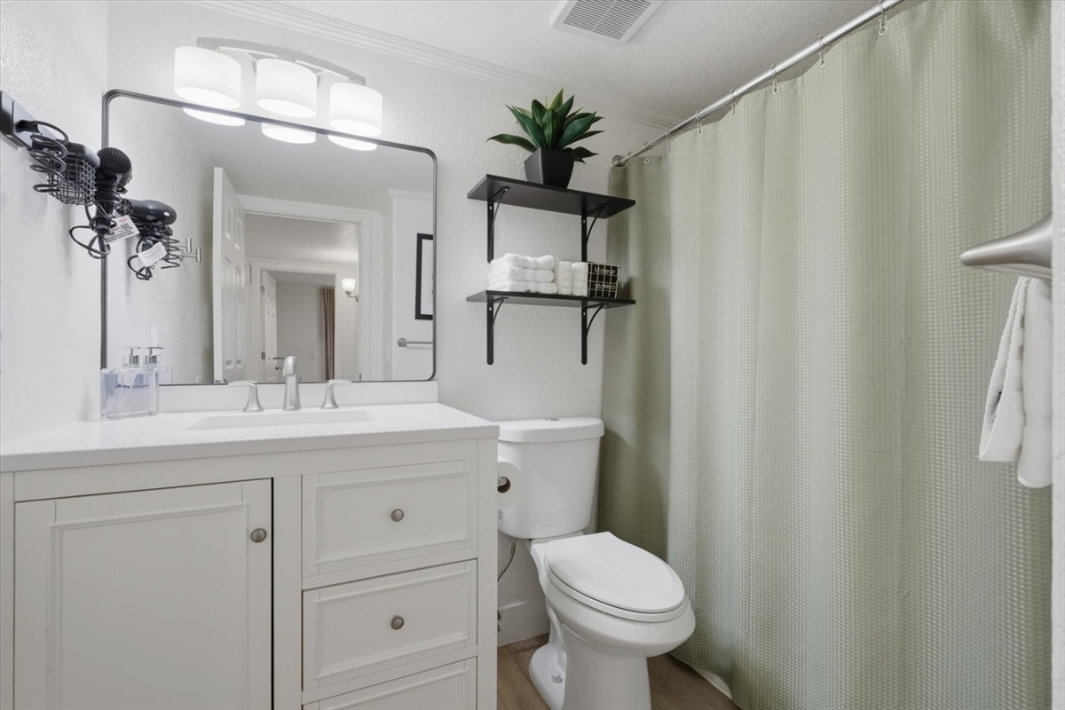 Downstairs full bathroom has shower/tub & is directly across from the downstairs King bedroom. Hair dryer & shower toiletries provided, plus a good amount of storage in the vanity.