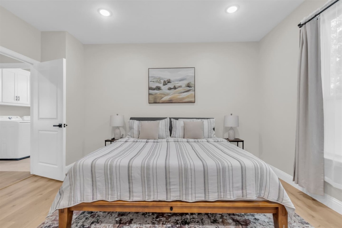 Master suite with neutral tones and stylish framed art.