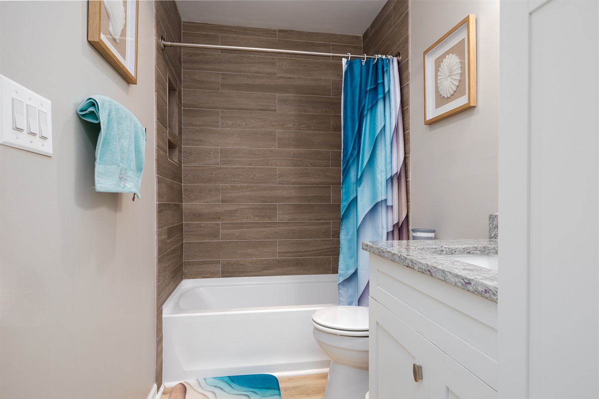 Spacious, clean bathroom with tiled shower