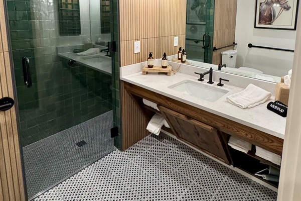 A closer look at the Homestead Suite ADA bathroom &mdash; accessible vanity, roll-in shower, and modern Western finishes built for full accessibility.