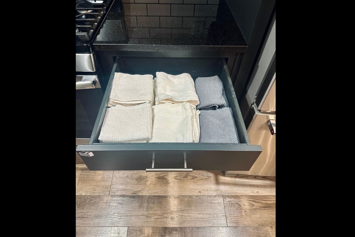 Kitchen drawer stocked with dish drying towels and hand towels to keep the space tidy and functional.