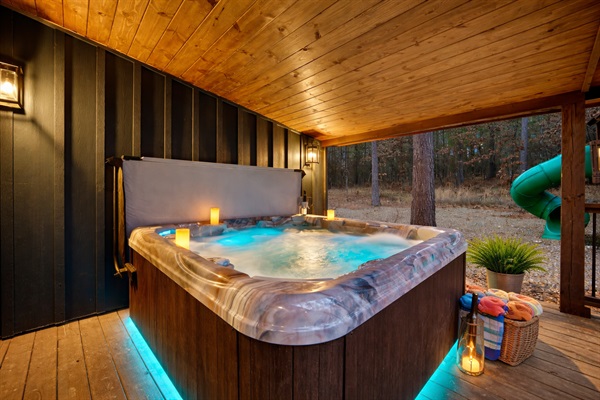 Covered hot tub with candlelight — perfect for crisp fall evenings & cozy winter nights.