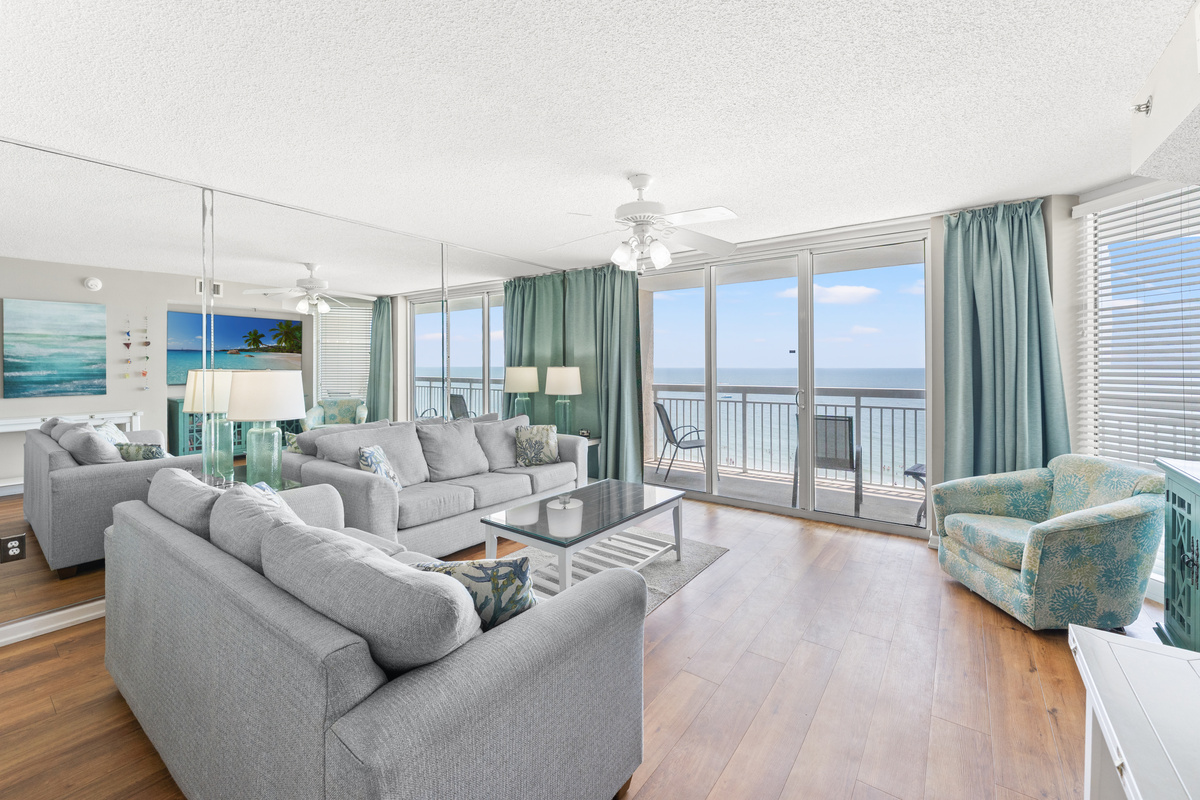Oceanfront Spacious Living Room with balcony access and large TV
