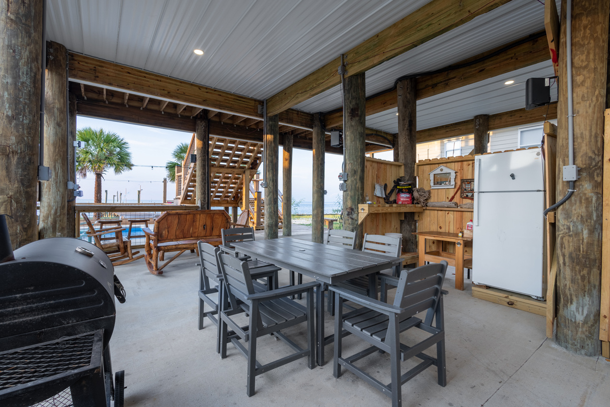 Outdoor dining with grill , refrigerator and dining table