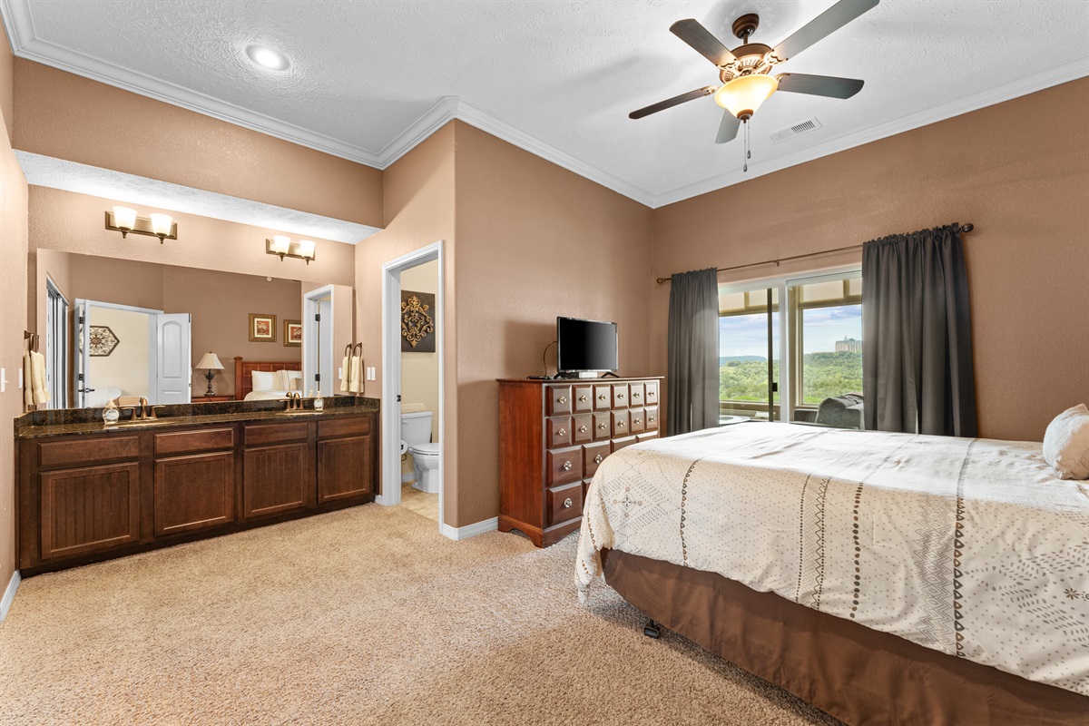The king suite feels especially spacious, with lake views, a TV, and a dual vanity just off the sleeping area.