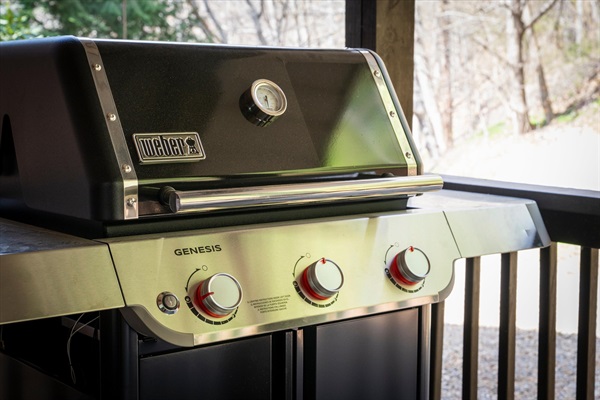 Weber grill just off the kitchen, connected to gas for easy outdoor cooking—perfect for meals without missing a moment.