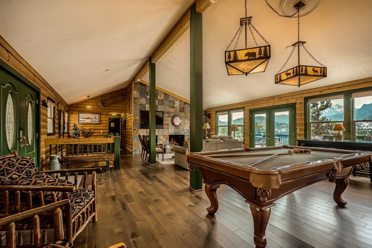 Living room and pool table with view of mountains